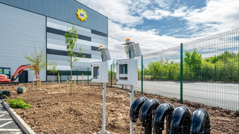 Landscaping, EV charging ducts and site fencing beside the XDock 549 offices